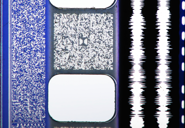 Macro of 35mm film and audio tracks: Sony SDDS, Dolby Digital, analog Optical and DTS time code.